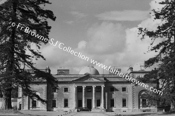 FRONTAL VIEW OF HOUSE WITH CLOUDS FROM AVENUE